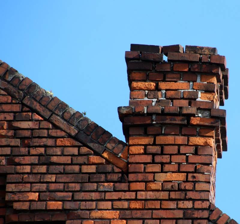 Damaged chimney on an Glendale home showing cracks and missing mortar